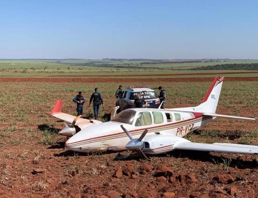Piloto interceptado com meia tonelada de cocaína estava solto por decisão do STF Policiais militares ao lado do avião abandonado em lavoura de cana, em Ivinhema (Foto: Divulgação)