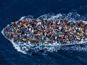 Unicef alerta para aumento da crise de crianças refugiadas na Europa Refugiados num barco à caminho da Europa. Foto: Guarda Costeira Italiana/Massimo Sestini