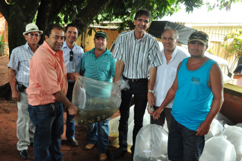 Prefeito Dirceu Lanzarini e autoridades realizando a entrega de alevinos para piscicultores de Amambai. 