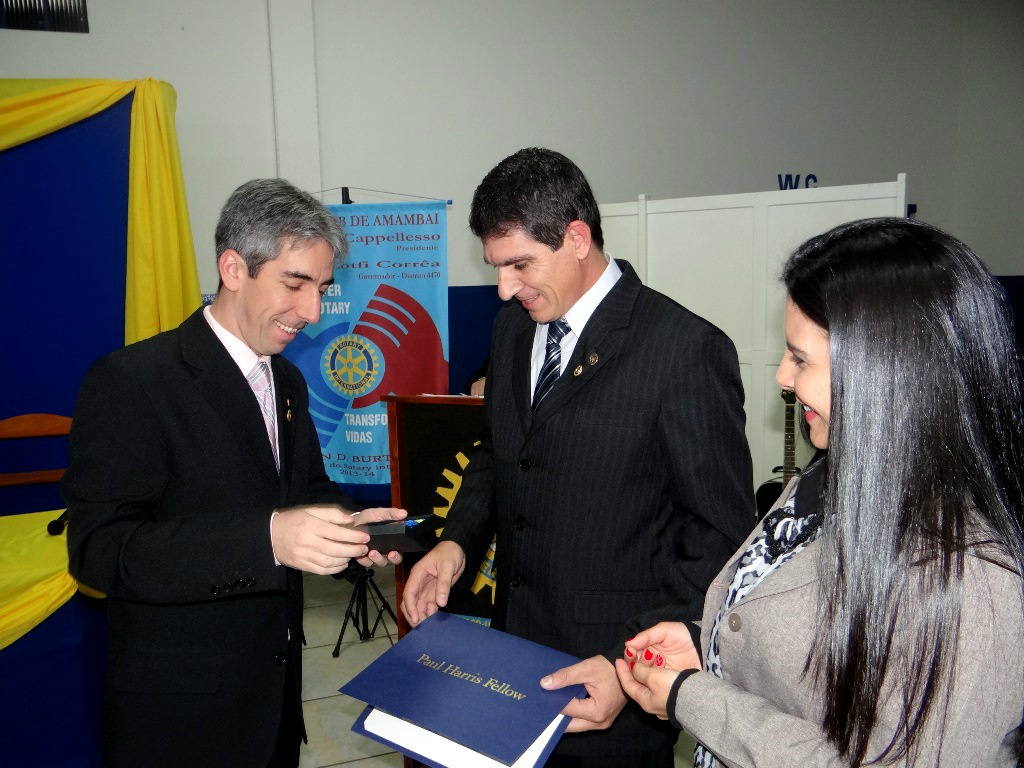 Conselho diretor 2014/2015 do Rotary de Amambai é empossado Cassiano entregando o título Paul Harris ao rotariano Edimilson, acompanhados pela esposa do agraciado Rosilei Charão.